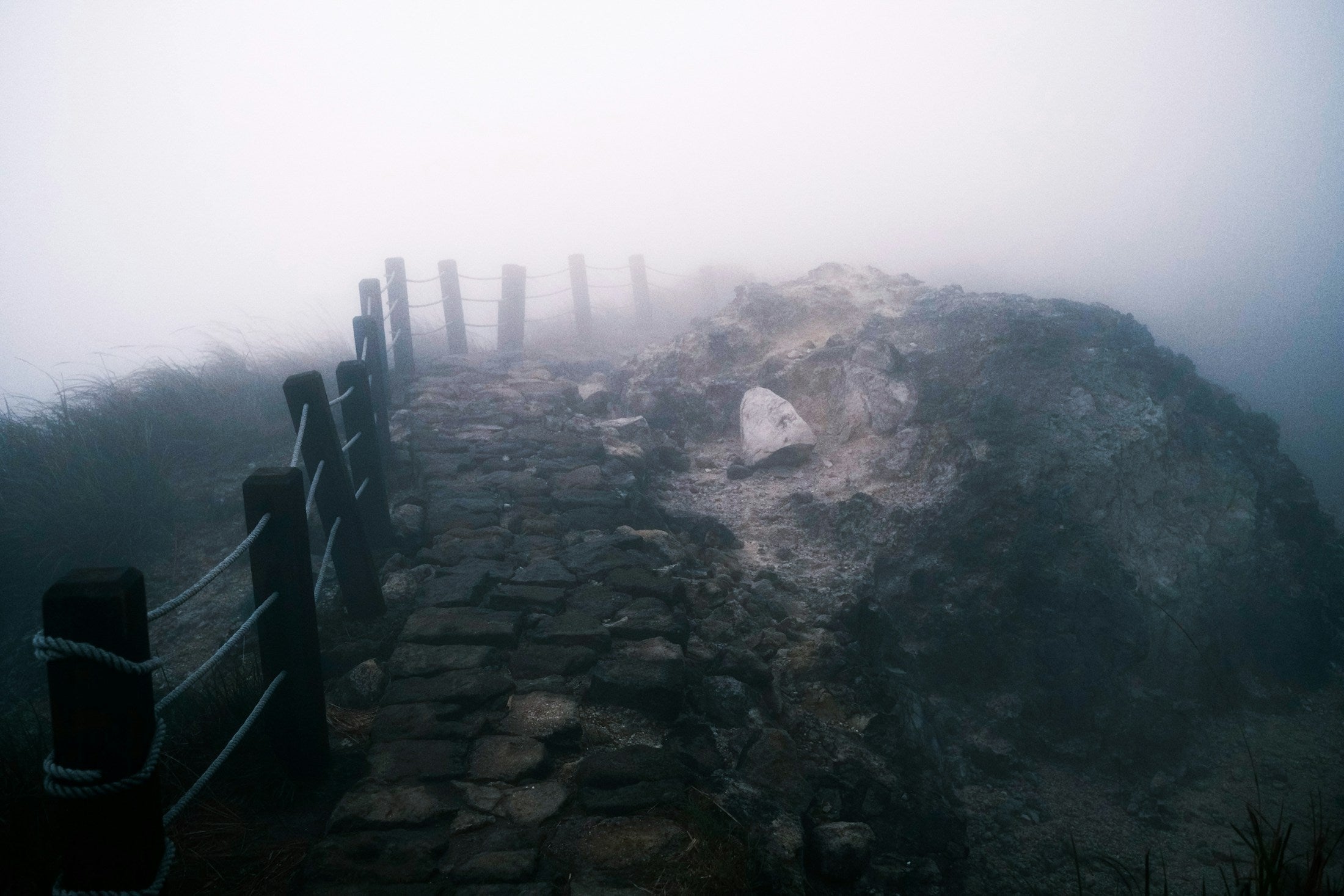 Stone stairs ascending into fog toward an unseen summit