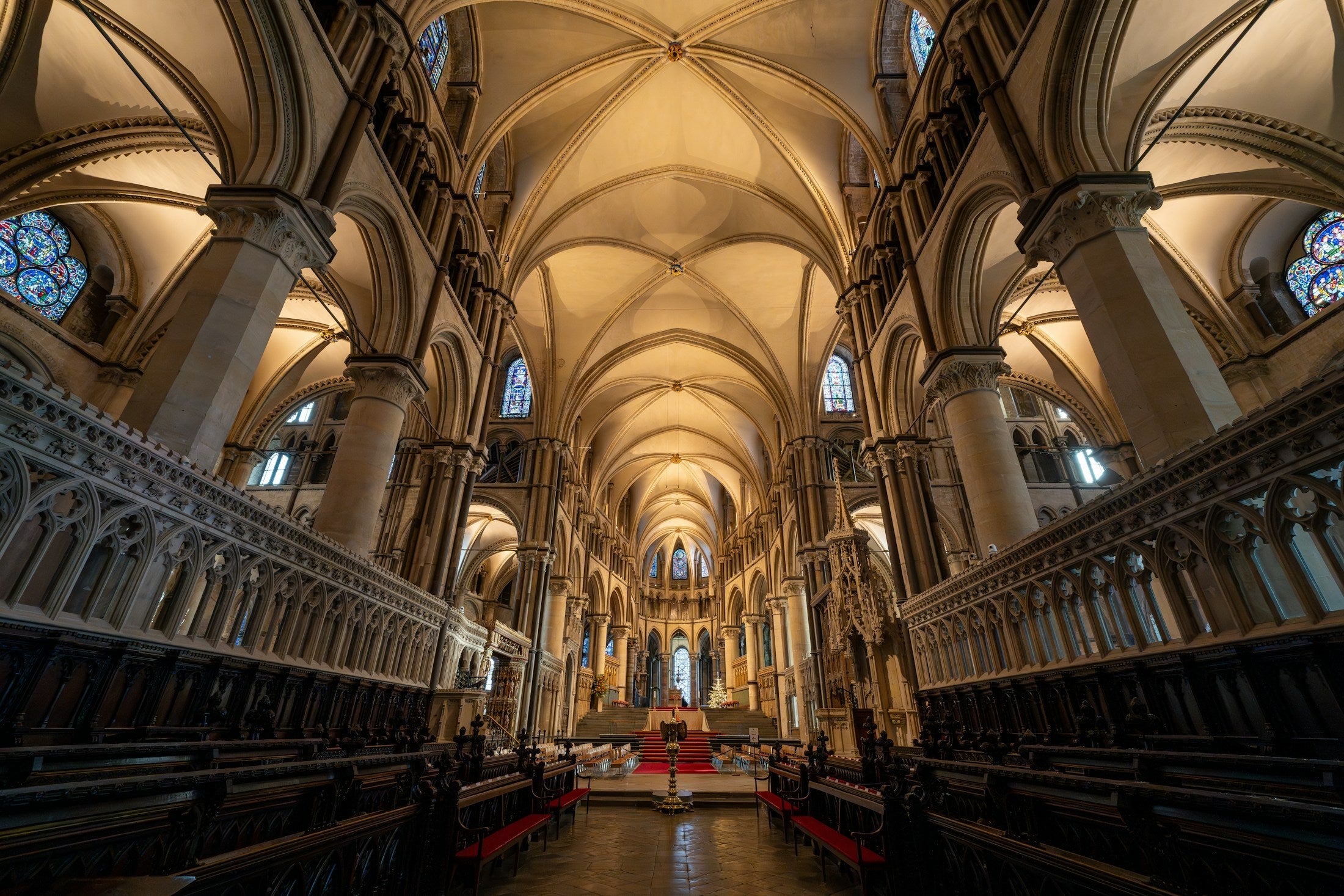 Interior of a large cathedral, many columns and windows forming one structure