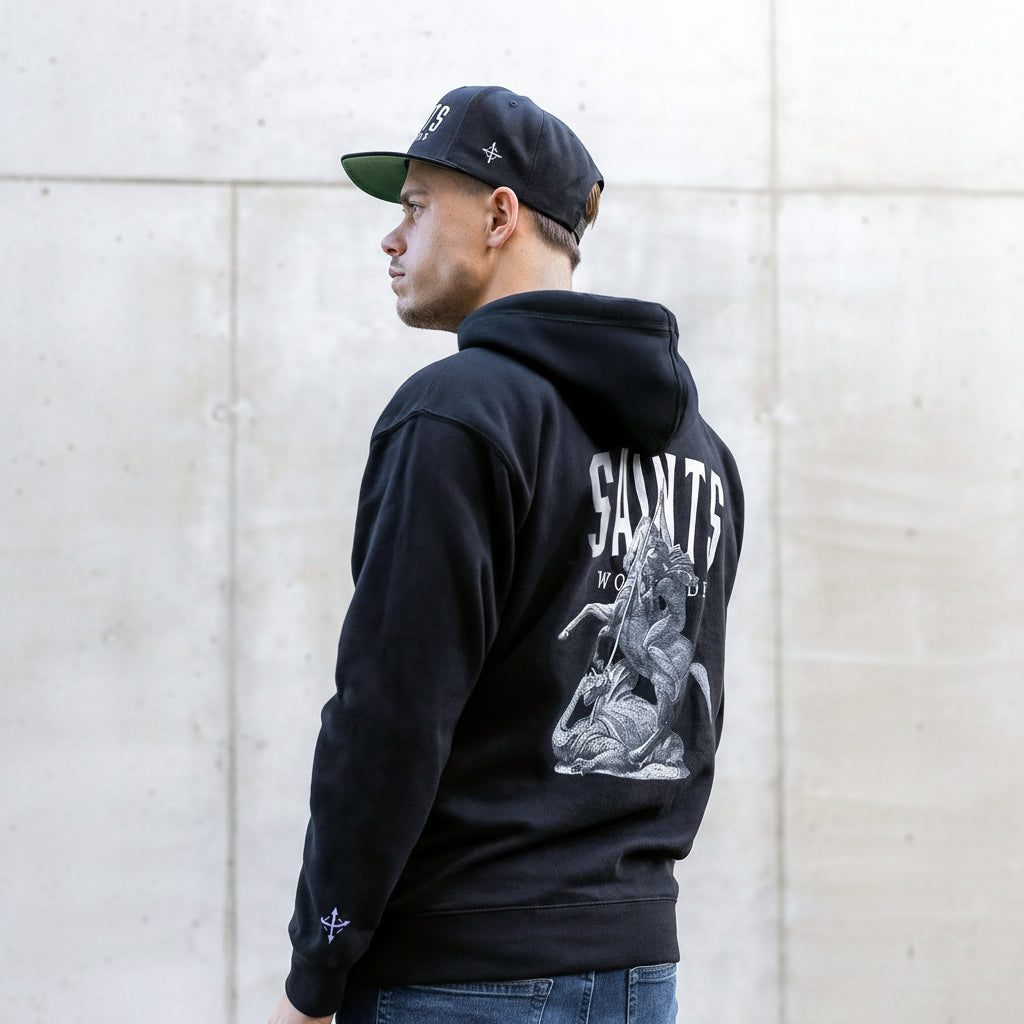 Male model wearing black Saints Worldwide Christian hoodie with back embroidery